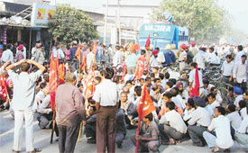 Workers protest against the closure of Rockman Cycle and Highway Industries in Ludhiana on Thursday