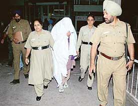 Rana Singh, escorted by cops, comes out of the Sector 16 General Hospital in Chandigarh on Friday