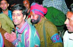 Rajan, an associate of Sumit Sahay, the local Congress leaders son, being led away by the police in Jalandhar on Friday. 