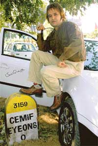 Well done: Rajan Chug proudly displays his autographed car. 