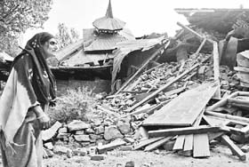 A Kashmiri woman watching the ruins of her house in the Uri sector