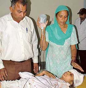 Vimla Devi stands near her daughter Amandeep Kaur at the DMC Hospital in Ludhiana