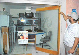 Paramjit Singh shows broken shutter locks of his shop in the Industrial Area, Chandigarh, on Sunday.