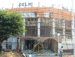 Workers engaged in creating a facsimile of the Parliament House at the Delhi pavilion 