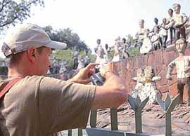 A foreign tourist captures creations of Nek Chand in his camera at Rock Garden in Chandigarh. 