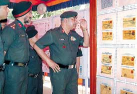 Lieut Gen Mandhata Singh, General Officer Commanding, takes a close look at a post card during the opening of a two-day philately exhibition organised by Army Postal Services, Vajra Corps, Jalandhar, on Monday