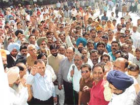 Employees of the Ludhiana Municipal Corporation stage a dharna outside its office on Monday