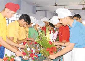 Students of Sacred Heart Convent School, Chandigarh Road, try their hands at flower arrangements at a competition held on the school premises in Ludhiana