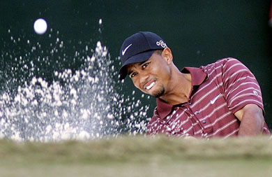 Tiger Woods of the USA hits from the sand trap on the 18th hole in the final round of The Tour Championship at East Lake Country Club in Atlanta on Sunday