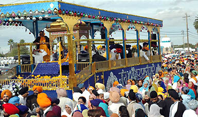 Sikh devotees participate in the procession taken out on the occasion of installation ceremony of Sri Guru Granth Sahib in Yuba City