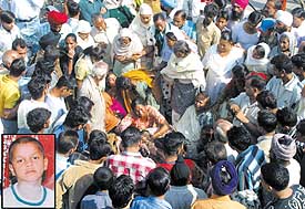 Residents of Dakoha village stage a dharna on the G.T. Road demanding action against an RMP for his negligence leading to the death of a boy Gangu (inset) in Jalandhar on Tuesday. 