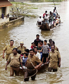 Firefighters rescue people from a flooded area of Chennai on Tuesday.