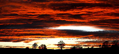 Clouds appear red in the sky as the sun sets near Jena, eastern Germany, on Monday