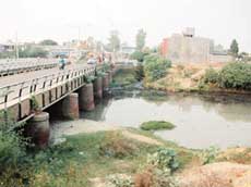 A view of the Tung Dhab drain across the Rajasansi Airport road.