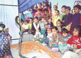 Students of Delhi Public School, Sector 40, enjoy a puppet show organised to mark Children's Day celebrations on the premises of the school in Chandigarh