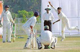 Amaninder Singh of Haryana bowls to Nitish Sharma of Jammu and Kashmir at the J.R. Institute of Cricket Technology grounds