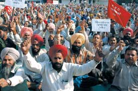 Members of PWD Mulazam Sangarsh Committee, Punjab, stage a protest dharna in Jalandhar on Wednesday. 