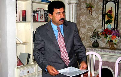 Khalil al-Dulaimi, chief lawyer for Iraq's former President Saddam Hussein, holds a letter indicating that he will stop all dealings with the tribunal trying Hussein during an interview in Ramadi on Wednesday