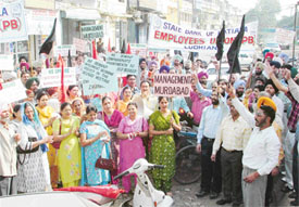 Employees of the State Bank of Patiala hold a rally in Ludhiana on Thursday