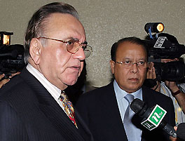 Bangladesh Foreign Minister M. Morshed Khan listens as Pakistan Foreign Minister Khursheed Mehmood Kasuri speaks to reporters after their informal meeting in Dhaka