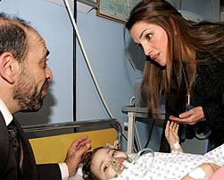 Jordan's Queen Rania visits an injured child at a hospital in Amman on Thursday