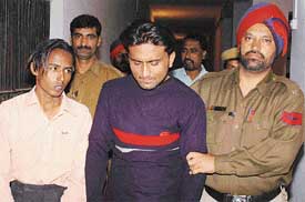 The alleged bank robbers in police custody in Ludhiana on Friday