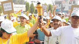 Special children from Pakistan carry a torch on the eve of the Punjab State Special Olympics 