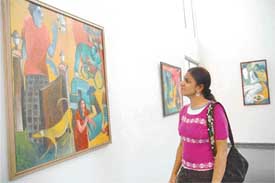A visitor has a look at the art-work on display at Museum of Fine Arts, Panjab University
