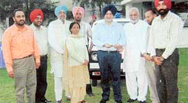 Members of the Hara Charitable Trust, along with other dignitaries, donate an ambulance van to the SSP, Ludhiana, Mr Narinderpal Singh, at Sahnewal on Saturday
