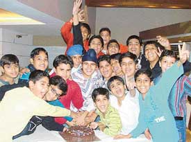 Students cut a cake on the eve of Children’s Day in Ludhiana on Sunday