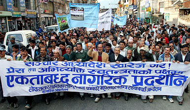 Nepal nationals march during a protest against the new media law, which curtails the freedom of press and bans news on FM radio, in Kathmandu on Sunday