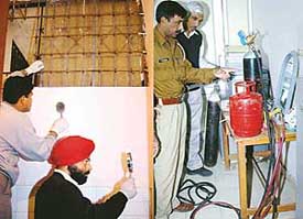 Forensic experts and police officers examine a spot at the Sector 34 branch of SBI following a robbery bid in Chandigarh on Monday