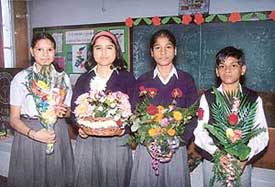 Students of Kendriya Vidalaya, Sector 31, pose with their prize-winning flower arrangements in Chandigarh on Monday