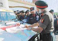 Brig H.S. Sandhu signs the route map of the artillery jeep expedition before flagging it off in Chandi Mandir on Tuesday. 