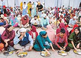 Devotees having langar during Gurpurb celebrations at the Sector 34 gurdwara in Chandigarh on Tuesday. 