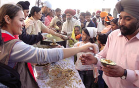 A Sikh family providing langar to the devotees at the historic Bangla Sahib Gurdwara in the Capital on Tuesday