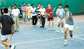 Players practising strokes.