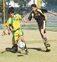 A St Xaviers player on his way to score a goal against Carmel Convent School, Nahan, during the ICSE Football Tournament in Chandigarh