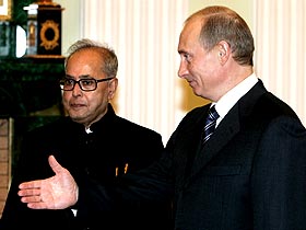 Russian President Vladimir Putin welcomes Defence Minister Pranab Mukherjee during their meeting in Moscow on Wednesday