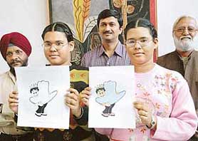 Rasleen Ahluwalia (left) and Harveen Ahluwalia, creators of the mascot for the forthcoming Chandigarh Carnival, show their design following the formal approval by the organisers in Chandigarh on Thursday.