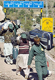 Kashmiris cross the Line of Control (LoC) near the damaged Kaman Bridge on Thursday.