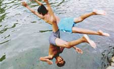 For these kids, the water heated up by the sun was cool enough to play and make a splash in