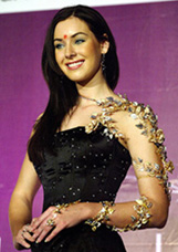Miss Universe, 2005, Natalie Glebova, displays a diamond-studded gold armband during a news conference in Mumbai on Friday. 