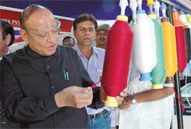 Mr Shankersinh Vaghela, Union Minister for Textiles, examines yarn during an exhibition on Textile Technology at Punjab Agricultural University, Ludhiana, on Friday