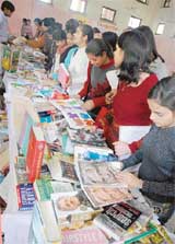 Students have a look at books at a book fair organised at Khalsa College for Women in Luhdiana on Friday