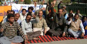 Non-teaching employees of private-aided colleges hold a demonstration at Arya College in Ludhiana on Friday