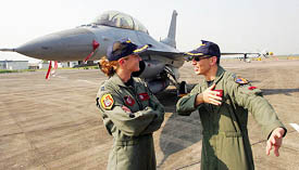 Capt Shannon Schneider (left) discusses a point with another pilot besides her missile-armed F-16 on the tarmac at the Kalaikunda Airbase near Kolkata.