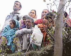 Residents of Kashmir watch their villagers cross over to Pakistan-occupied Kashmir in Teetwal, 195 km northwest of Srinagar, on Saturday.