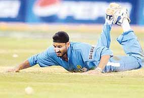 Harbhajan Singh dives to stop the ball during the second one-day international in Bangalore on Saturday.