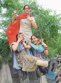 It seems to be a scene from Teej festival as it was celebrated in the sawan of old in the villages of Punjab. 